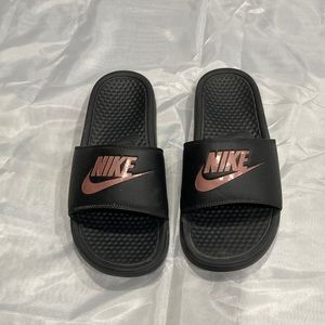 Women’s black Nike slip-ons